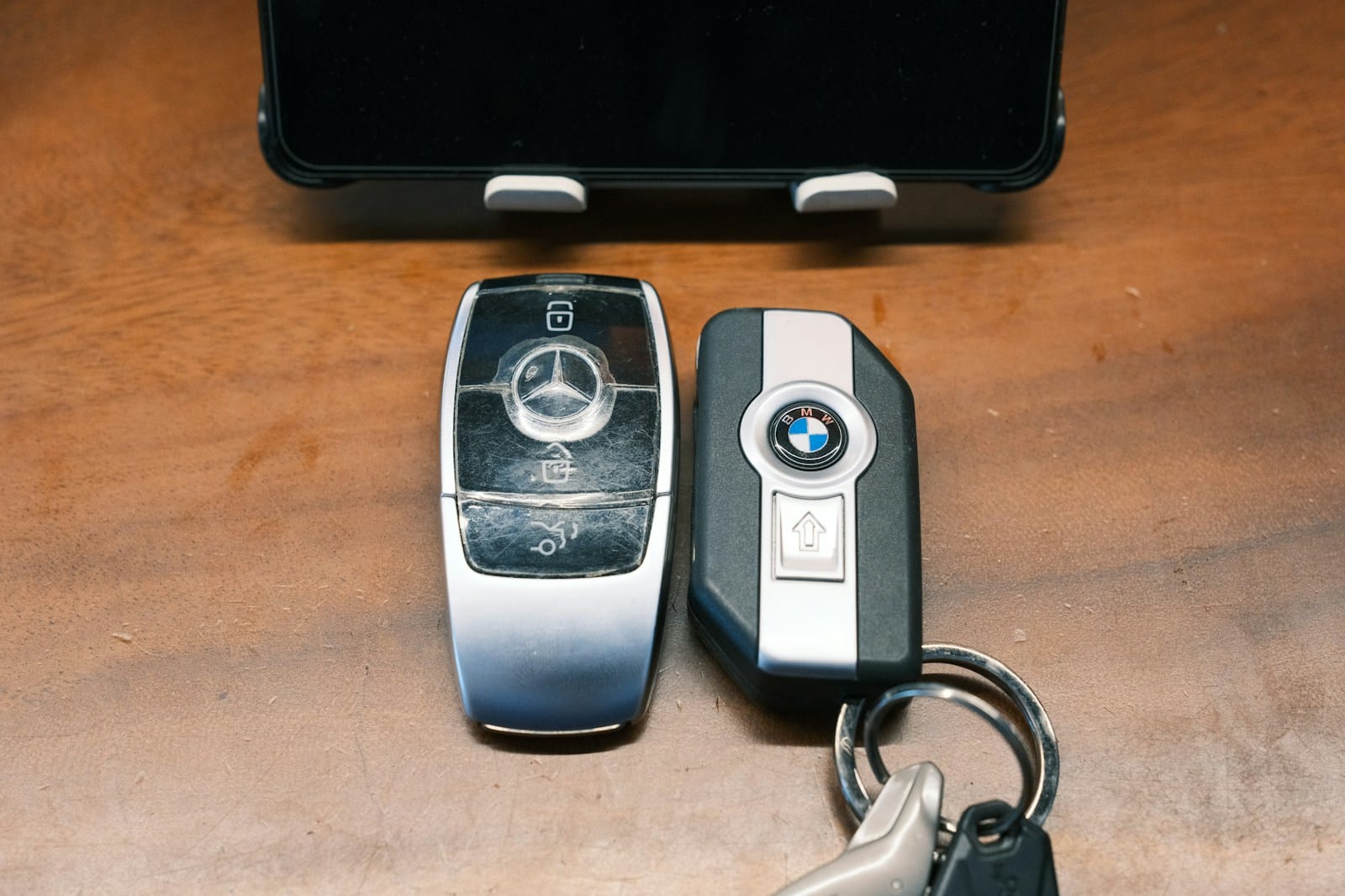 Mercedes and BMW car keys rest on a table.