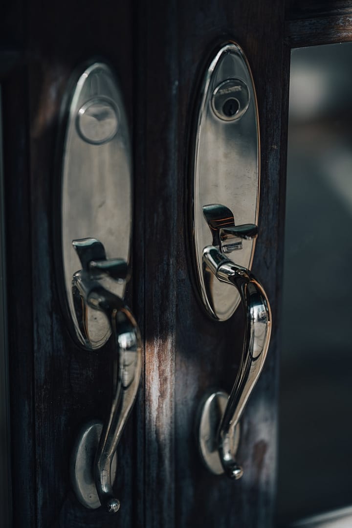 a close up of a door handle on a wooden door